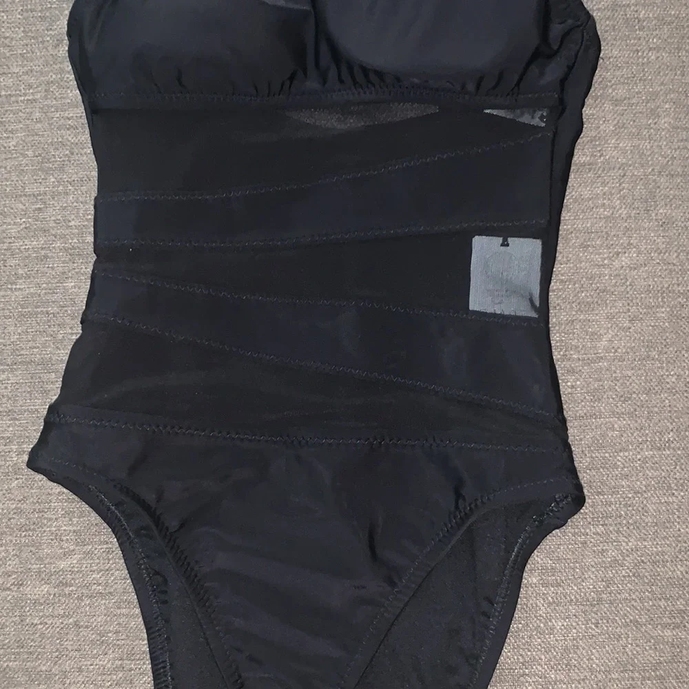 Cute black bathing suit. Mesh striping through middle. Size small NWT